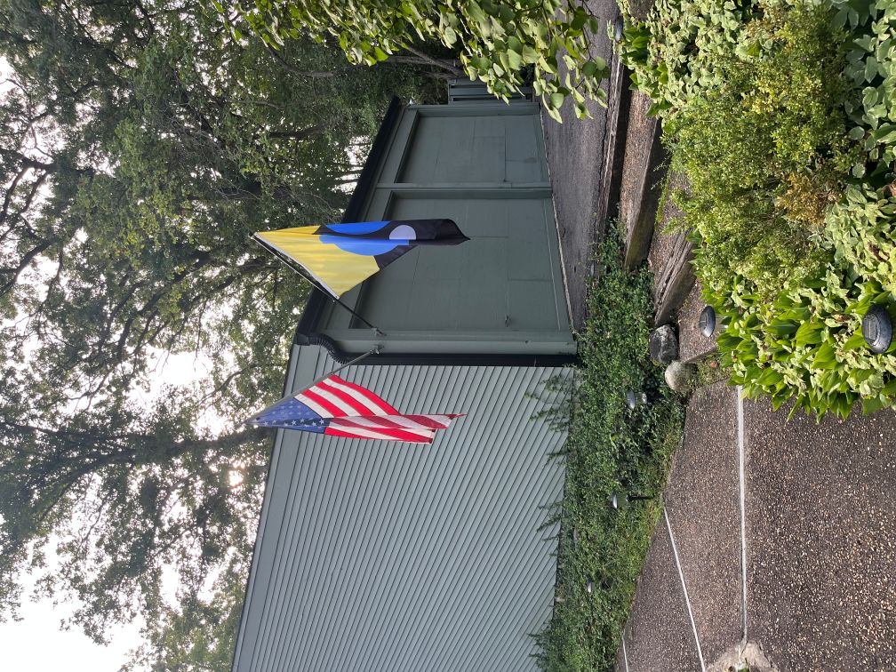 A Flag of Earth flying alongside the American flag outside a home in St. Charles, Illinois